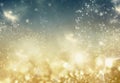 holiday abstract glitter background with blinking stars and falling snowflakes. Blurred bokeh of Christmas lights Royalty Free Stock Photo