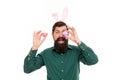 Holiday accessories. Celebration of spring holiday. Bearded man with bunny ears and Easter eggs. Hipster with long ears