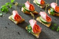 Holiday appetizer: Canapes on crispy bread with cucumber, carrots and sausage