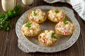 Holiday appetizer: tartlets with crab sticks, cheese and pineapple on a wooden table