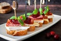 Holiday appetizers with cranberry sauce on a white serving plate