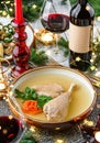 Holiday aspic or galantine with chicken in plate on wooden table served with plates, glasses, bottle of wine, candles, fir Royalty Free Stock Photo