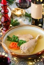 Holiday aspic or galantine with chicken in plate on wooden table served with plates, glasses, bottle of wine, candles, fir Royalty Free Stock Photo