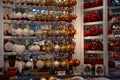 White, golden and red Christmas ornaments in shape of glass balls hanging on shelves at Christmas fair in Berlin Germany Royalty Free Stock Photo