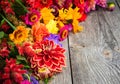 Holiday autumn bouquet. Frame of colorful flowers arranged on old wooden background. Royalty Free Stock Photo