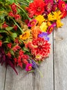 Holiday autumn bouquet. Frame of colorful flowers arranged on old wooden background. Royalty Free Stock Photo