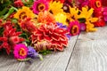 Holiday autumn bouquet. Frame of colorful flowers arranged on old wooden background. Royalty Free Stock Photo