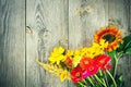 Holiday autumn bouquet. Frame of colorful flowers arranged on old wooden background. Royalty Free Stock Photo