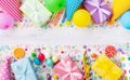 Holiday background with balloons, gift boxes and confetti. Birthday and party supplies on white table top view. Banner format