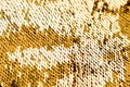 Background from gold glitter paillettes, close up. Metallic Glitter background , Golden sequins, sparkling sequined textile