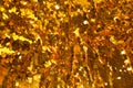 Holiday background from gold glitter paillettes, close up. Royalty Free Stock Photo