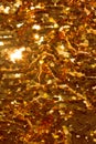 Holiday background from gold glitter paillettes, close up. Royalty Free Stock Photo