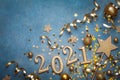 Holiday background with golden Christmas decorations and New year 2021 numbers and confetti top view