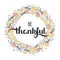 Holiday background with hand drawn words be thankful in a frma emade of leaves and berries