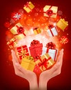 Holiday background with hands holding gift boxes