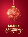 Holiday background. Hanging Christmas red ball on red. Sparkling metal glitter bauble. Merry Christmas hand drawn text Royalty Free Stock Photo