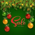 Christmas sale on green knitted background with fir tree branches and baubles