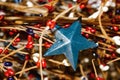 Holiday background with red white and blue blurred elements - focus on rustic blue metal star Royalty Free Stock Photo