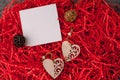 Holiday background for Valentine`s Day on a gray cement background with red chopped wrapping paper and hearts