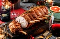 Holiday baked meat tenderloin with ribs, pork, roast beef Rump on dark wooden board with glasses