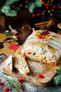 Holiday baking. Christmas cake. Stollen is fruit bread of nuts, spices, dried or candied fruit, coated with powdered sugar. It is Royalty Free Stock Photo