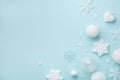 Holiday balls and decorative snowflakes on turquoise pastel background. Christmas or New year card. Minimalistic flat lay Royalty Free Stock Photo