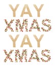 Holiday banner concept. Word YAY XMAS on white background.Symbol letters collected from the Christmas decor - acorns, cones,