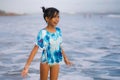 Beach lifestyle portrait of young beautiful and happy Asian child girl 8 or 9 years old with cute double buns hair style playing Royalty Free Stock Photo