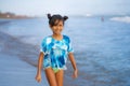 Beach lifestyle portrait of young beautiful and happy Asian child girl 8 or 9 years old with cute double buns hair style playing Royalty Free Stock Photo