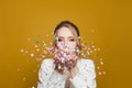 Holiday birthday background with happy woman and colorful falling confetti