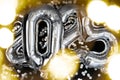 Holiday bokeh garland Happy new year 2025 metallic balloons with confetti on dark black background. Greeting card silver