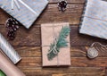 Holiday boxes with beautiful bonnets and a Christmas tree branch on a wooden table