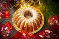Holiday bundt cake with icing on dark wooden table Royalty Free Stock Photo