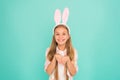 Holiday bunny girl posing with cute long ears. Child smiling play bunny role. Happy childhood. Traditions for kids to