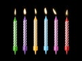 Holiday candles. Burning candle different colors with flickering fire, holiday candlelight, birthday cake decor, wax and