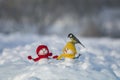 Holiday card titmice sit on cute snowmen in winter park