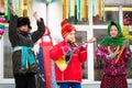 Holiday Carnival. Winter snow. Children with donuts. We are seeing winter. Children`s performance at a concert