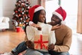 Portrait of happy black family celebrating Christmas giving present Royalty Free Stock Photo