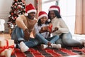 Portrait of happy black family in santa hants celebrating Christmas Royalty Free Stock Photo