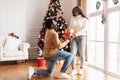 Portrait of happy black family celebrating Christmas, man giving present Royalty Free Stock Photo