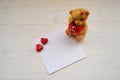 Holiday celebration. Valentines day gift. Teddy bear toy with paper for text
