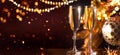 Holiday Champagne Flute over Golden glowing background. Christmas and New Year celebration. Two Flutes with Sparkling Wine Royalty Free Stock Photo