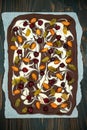 Holiday chocolate bark with dried fruits and nuts on a dark wood background. Top view. Dessert recipe for judaic holiday Tu Bishva Royalty Free Stock Photo