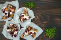 Holiday chocolate bark with dried fruits and nuts on a dark wood background. Top view. Dessert recipe for judaic holiday Tu Bishva