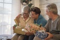 Holiday christmas eve and caucasian people family enjoying and sharing gifts and presents - teenager grandson with grandfathers