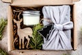 Holiday christmas gift box with present, candle, wooden toy. Care package concept. Top view, flat lay