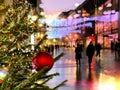 Holiday city street light  Christmas tree decorated red balls and illumination on ,people walking ,Night blurred blue red yellow l Royalty Free Stock Photo
