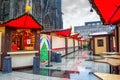 Holiday cityscape - view of empty the Christmas Market Weihnachtsmarkt early morning on background the Cologne Cathedral