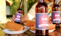 Holiday composition with multiple bottles of beer and hot dogs, American flag. Group of people celebrating Independence day of USA Royalty Free Stock Photo