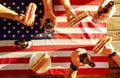 Holiday composition with multiple bottles of beer and hot dogs, American flag. Group of people celebrating Independence day of USA Royalty Free Stock Photo